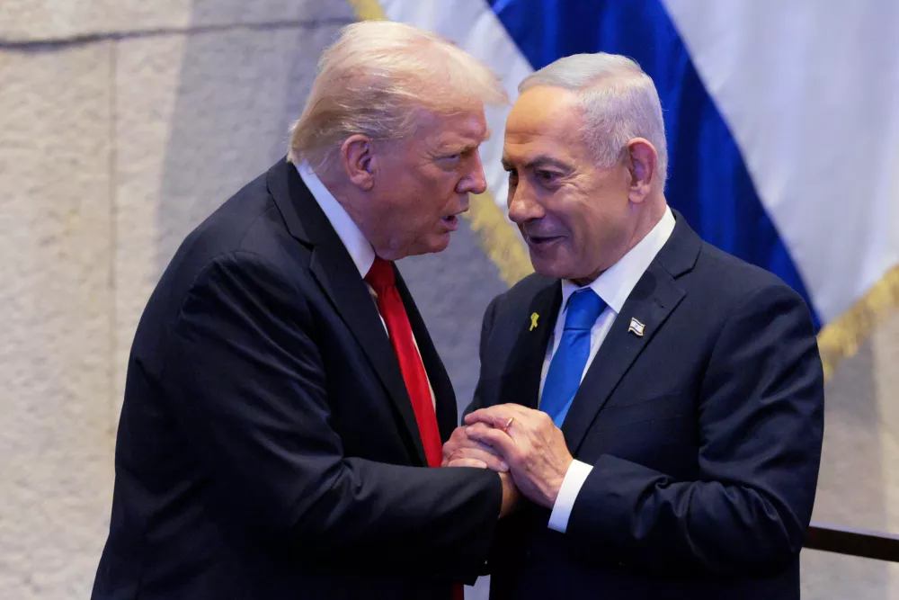 President Donald Trump talks with Israel's Prime Minister Benjamin Netanyahu at the Knesset, Israel's parliament, Monday, Oct. 13, 2025, in Jerusalem. (Chip Somodevilla/Pool via AP)