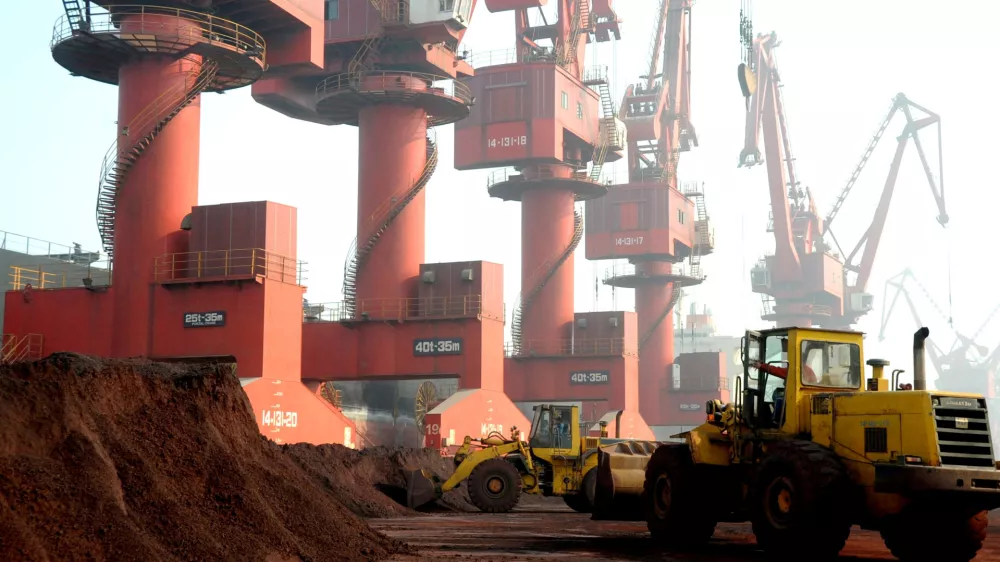 FILE PHOTO: Workers transport soil containing rare earth elements for export at a port in Lianyungang, Jiangsu province, China, October 31, 2010. REUTERS/Stringer ATTENTION EDITORS - THIS IMAGE WAS PROVIDED BY A THIRD PARTY. CHINA OUT./File Photo