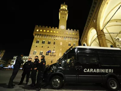 Florence, Italy - December 15 2021: The monuments of the historic center presided over by the Carabinieri: Palazzo Vecchio and the Loggia dei Lanzi in Piazza della Signoria.