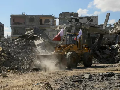 Heavy machinery removes debris from a street, amid a ceasefire between Israel and Hamas, in Gaza City, October 14, 2025. REUTERS/Ebrahim Hajjaj