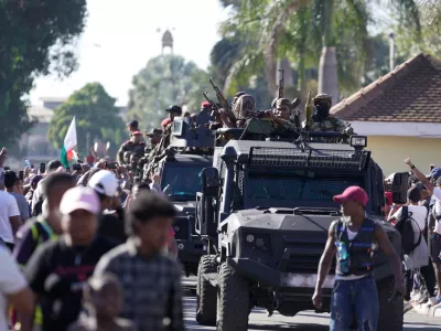 Troops loyal to CAPSAT military unit commander Col. Michael Randrianirina make their way to the Presidency to announce that the armed forces are taking control of the country in Antananarivo, Madagascar, Tuesday, Oct. 14, 2025. (AP Photo/ Brian Inganga)