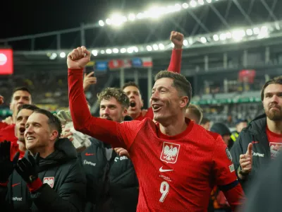 Poland's Robert Lewandowski celebrates with teammates after the World Cup 2026 group G qualifying soccer match between Lithuania and Poland at Darius and Girenas stadium in Kaunas, Lithuania, Sunday, Oct. 12, 2025. (AP Photo/Mindaugas Kulbis)