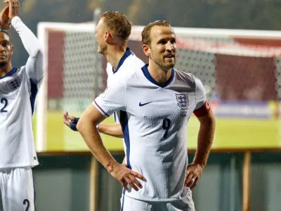 England's Harry Kane greets England's travelling support after the 2026 World Cup group K qualifying soccer match between Latvia and England in Riga, Latvia, Tuesday, Oct. 14, 2025. (AP Photo/Mindaugas Kulbis)