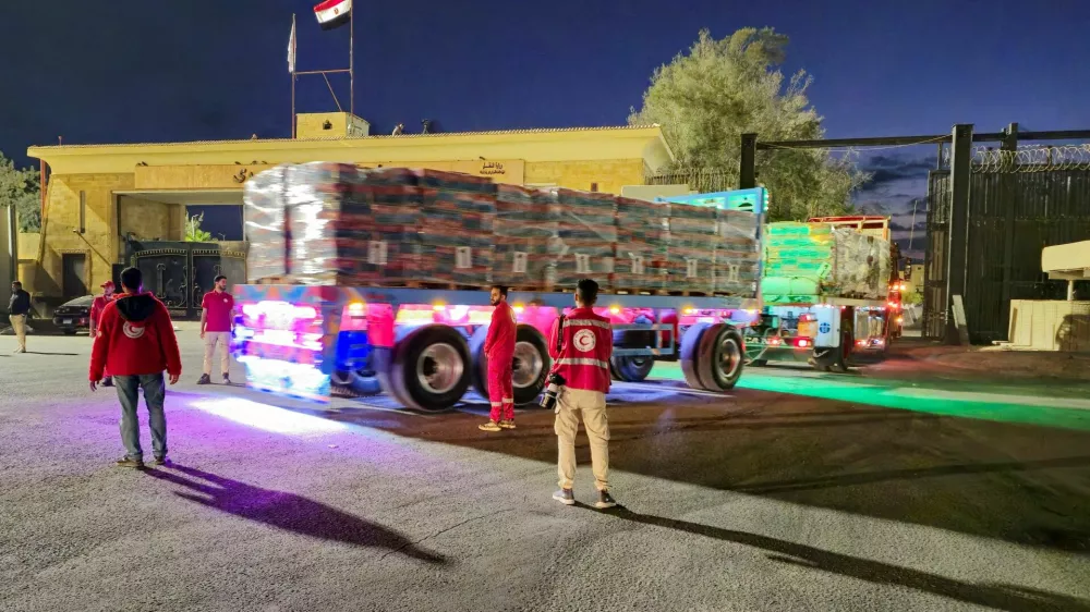 FILE PHOTO: Trucks carrying aid bound for Gaza cross the border crossing between Egypt and the Gaza Strip, after a ceasefire between Israel and Hamas in Gaza went into effect, in Rafah, Egypt, October 12, 2025. REUTERS/Stringer/File Photo