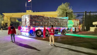 FILE PHOTO: Trucks carrying aid bound for Gaza cross the border crossing between Egypt and the Gaza Strip, after a ceasefire between Israel and Hamas in Gaza went into effect, in Rafah, Egypt, October 12, 2025. REUTERS/Stringer/File Photo