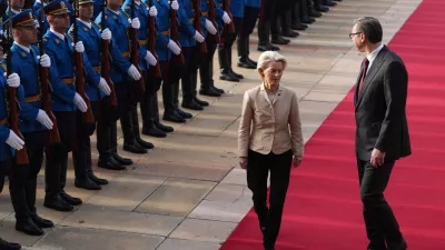 European Commission President Ursula von der Leyen, left, reviews the honor guard with Serbian President Aleksandar Vucic during a welcome ceremony at the Serbia Palace in Belgrade, Serbia, Wednesday, Oct. 15, 2025. (AP Photo/Darko Vojinovic)