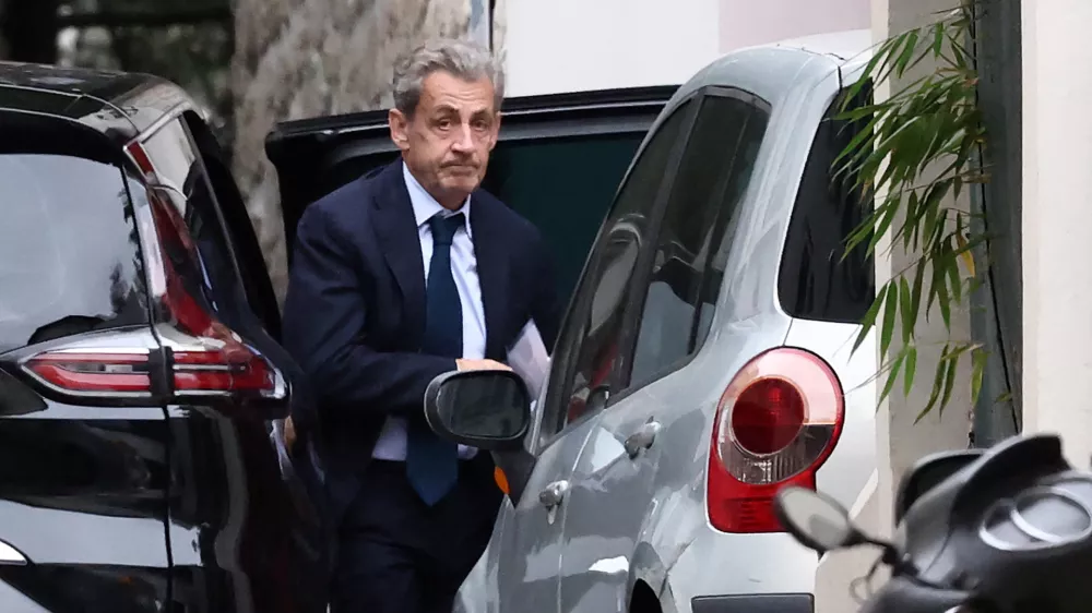 Former French President Nicolas Sarkozy leaves his car as he arrives at his home after being notified of his incarceration date by the National Financial Prosecutor's Office (PNF), following a five-year sentence for criminal conspiracy over attempts to raise campaign funds from Libya, in Paris, France, October 13, 2025. REUTERS/REUTERS/Stephane Mahe