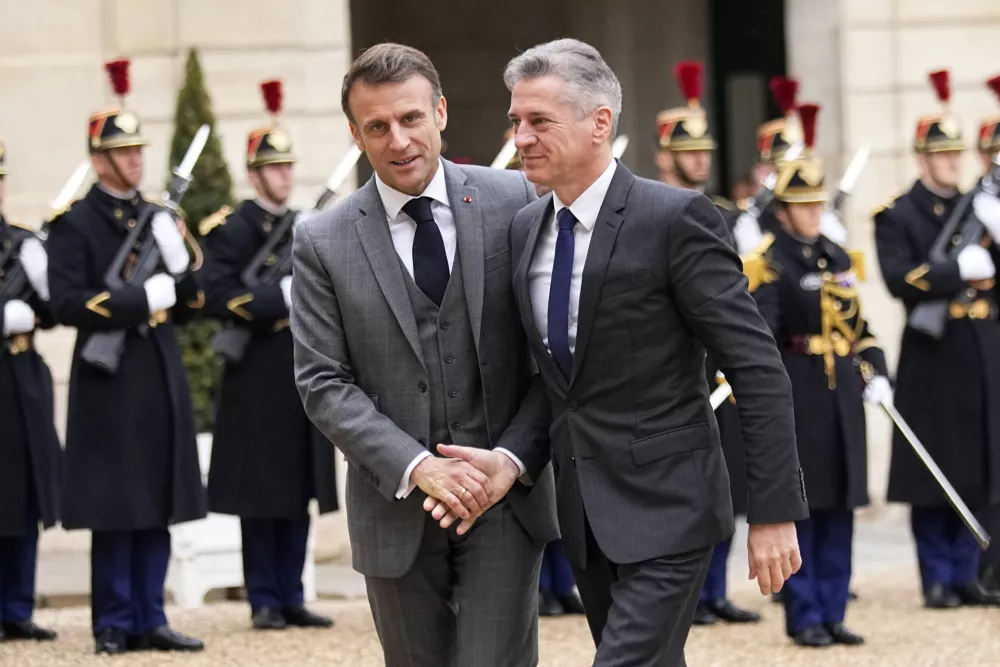 French President Emmanuel Macron, left, welcomes Slovenia's Prime Minister Robert Golob, Wednesday, Dec. 13, 2023 at the Elysee Palace in Paris. (AP Photo/Michel Euler)