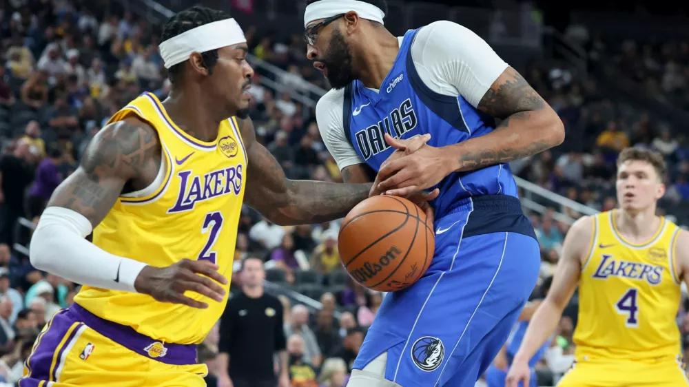Los Angeles Lakers forward Jarred Vanderbilt (2) knocks the ball away from Dallas Mavericks forward Anthony Davis (3) during the first half of a preseason NBA basketball game Wednesday, Oct. 15, 2025, in Las Vegas. (AP Photo/Ian Maule)