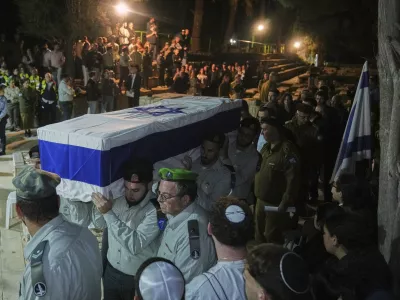 Israeli soldiers carry the coffin of slain hostage Captain Daniel Peretz during his funeral at Mt. Herzl military cemetery in Jerusalem, Wednesday, Oct. 15, 2025. (AP Photo/Francisco Seco)
