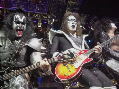 FILE - Kiss guitarist Paul Stanley, right, guitarist Ace Frehley, center, and bassist Gene Simmons play during the band's farewell concert in the Detroit area, Thursday, May 25, 2000, at the Palace of Auburn Hills, Mich.. (AP Photo/Paul Warner, File)