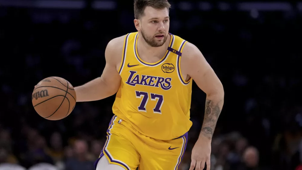 Los Angeles Lakers guard Luka Doncic (77) dribbles up the court during the first half of Game 2 of an NBA first-round playoff series against the Minnesota Timberwolves in Los Angeles, Tuesday, April 22, 2025. (AP Photo/Eric Thayer)