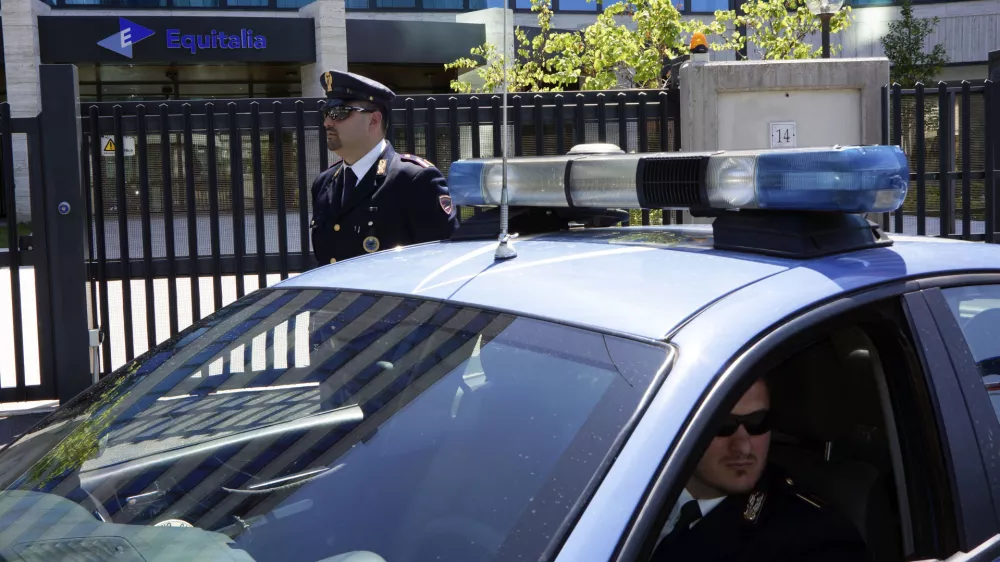 Italian Police officers are seen outside Equitalia tax collection agency headquarters after a letter bomb was intercepted at the offices, in Rome, Friday, May 11, 2012. The letter contained a small amount of explosive, but according to investigators it most probably was unable to explode. In Dec. 2011 the director of another Equitalia office was injured when he opened an envelope addressed to him containing explosives. (AP photo/Domenico Stinellis)