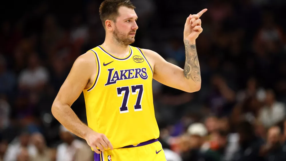 Oct 14, 2025; Phoenix, Arizona, USA; Los Angeles Lakers guard Luka Doncic (77) reacts against the Phoenix Suns during an NBA preseason game at Mortgage Matchup Center. Mandatory Credit: Mark J. Rebilas-Imagn Images