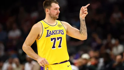Oct 14, 2025; Phoenix, Arizona, USA; Los Angeles Lakers guard Luka Doncic (77) reacts against the Phoenix Suns during an NBA preseason game at Mortgage Matchup Center. Mandatory Credit: Mark J. Rebilas-Imagn Images