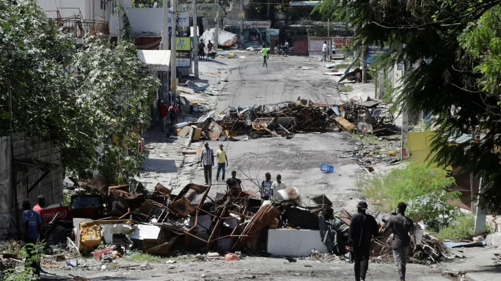 FILE PHOTO: Residents return to the Route de Nazon neighborhood after gang leader Jimmy "Barbeque" Cherizier withdrew his soldiers from several neighborhoods in northeastern Port-au-Prince and urged former residents to return to their homes, in Port-au-Prince, Haiti August 28, 2025. REUTERS/Jean Feguens Regala/File Photo