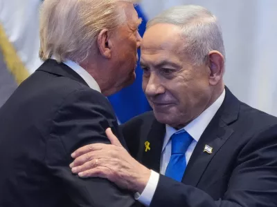 FILE PHOTO: President Donald Trump talks with Israel's Prime Minister Benjamin Netanyahu at the Knesset, Monday, Oct. 13, 2025, in Jerusalem.   Evan Vucci/Pool via REUTERS/File Photo