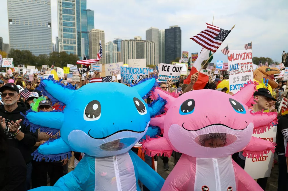 Demonstrators wearing inflatable costumes take part in a "No Kings" protest against U.S. President Donald Trump's policies, in Chicago, Illinois, U.S., October 18, 2025. REUTERS/Jim Vondruska