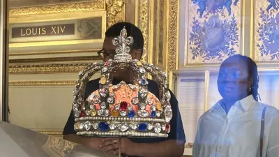 People check jewelry in the Apollo Gallery of the Louvre museum on Sept. 4, 2025 in Paris. (AP Photo/Alexander Turnbull)
