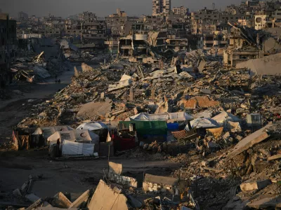 Tents for displaced Palestinians stand amid the destruction caused by the Israeli air and ground offensive in Sheikh Radwan neighborhood in Gaza City, Wednesday, Oct. 22, 2025. (AP Photo/Abdel Kareem Hana)