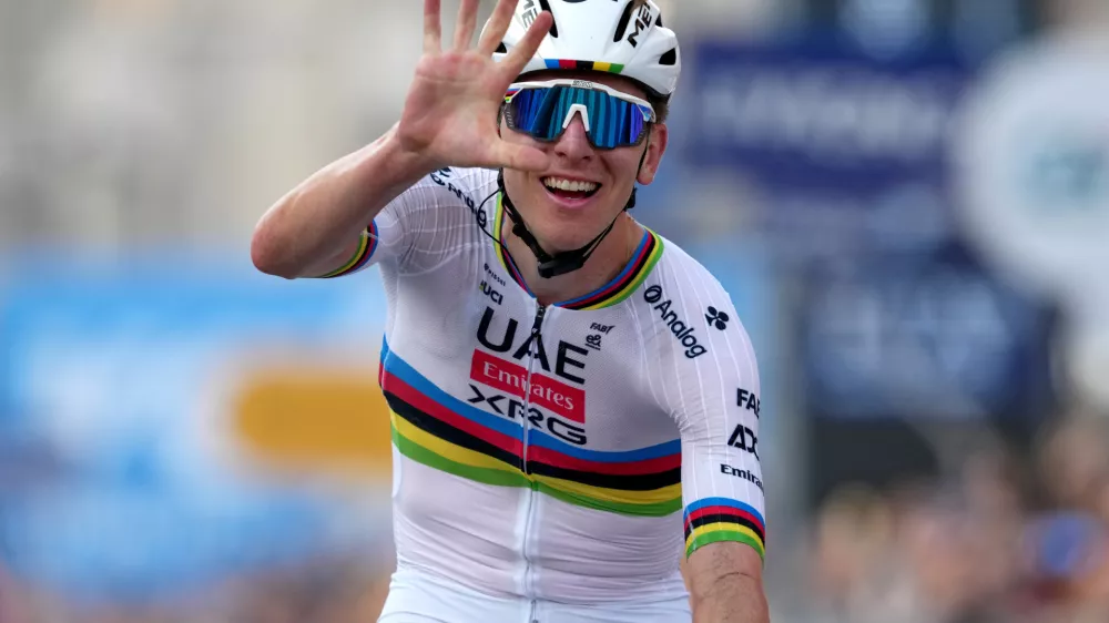 Reigning World Champion Tadej Pogacar indicates five as he celebrates winning his fifth in a row Il Lombardia, Tour of Lombardy cycling race, in Bergamo, Italy, Saturday, Oct. 11, 2025. (Gian Mattia D'Alberto/LaPresse via AP)