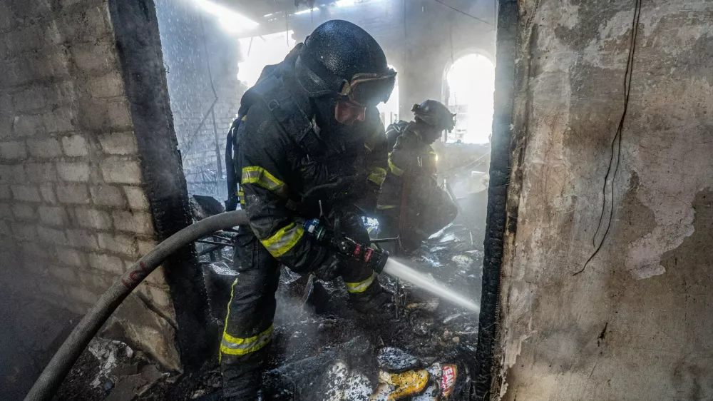 Firefighters put out the fire after Russian drones hit a city kindergarten during an air attack in Kharkiv, Ukraine, Wednesday, Oct. 22, 2025. (AP Photo/Andrii Marienko)