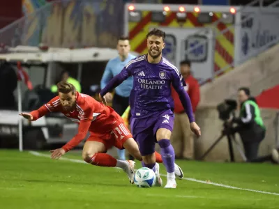 Oct 22, 2025; Bridgeview, Illinois, USA; Chicago Fire FC midfielder Philip Zinckernagel (11) and Orlando City defender David Brekalo (4) battle for control of the ball during the first half at SeatGeek Stadium. Mandatory Credit: Talia Sprague-Imagn Images