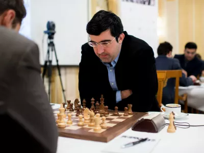 FILE - Russian chess grandmaster Vladimir Kramnik, right, concentrates during his game against U.S. grandmaster Lewon Aronjan during the Zurich Chess Challenge 2015 Round 3 in Zurich, Feb. 16, 2015. (Ennio Leanza/Keystone via AP)