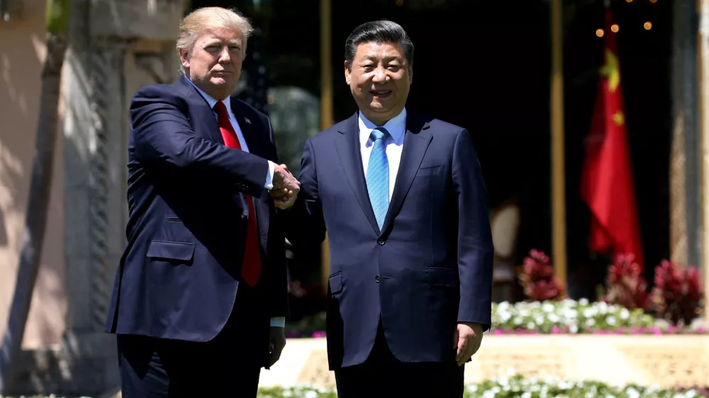 FILE PHOTO: U.S. President Donald Trump (L) and China's President Xi Jinping shake hands while walking at Mar-a-Lago estate after a bilateral meeting in Palm Beach, Florida, U.S., April 7, 2017. REUTERS/Carlos Barria/File Photo