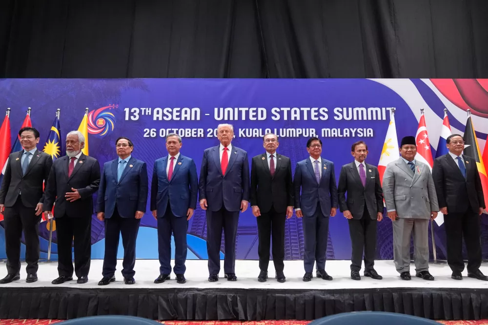 President Donald Trump poses for a family photo with, from left, Singapore Prime Minister Lawrence Wong, East Timor's Prime Minister Kay Rala Xanana Gusmao, Vietnam's Prime Minister Pham Minh Chinh, Cambodian Prime Minister Hun Manet, Malaysian Prime Minister Anwar Ibrahim, Philippine President Ferdinand Marcos Jr., the Sultan of Brunei Hassanal Bolkiah, Indonesian President Prabowo Subianto and Laos' Prime Minister Sonexay Siphandone at the ASEAN Summit in Kuala Lumpur, Malaysia, Sunday, Oct. 26, 2025. (AP Photo/Mark Schiefelbein)