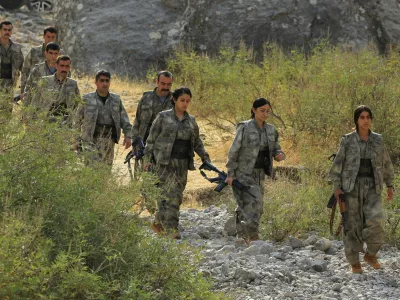 Fighters with the Kurdistan Workers' Party (PKK) walk for a disarmament ceremony marking a significant step toward ending the decades-long conflict between Turkey and the outlawed group in the Qandil mountains, Iraq October 26, 2025. REUTERS/Thaier Al-Sudani