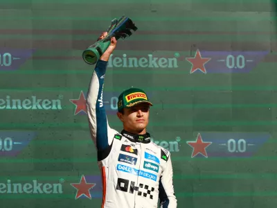 Formula One F1 - Mexico City Grand Prix - Autodromo Hermanos Rodriguez, Mexico City, Mexico - October 26, 2025 McLaren's Lando Norris celebrates with a trophy on the podium after winning the Mexico City Grand Prix REUTERS/Raquel Cunha