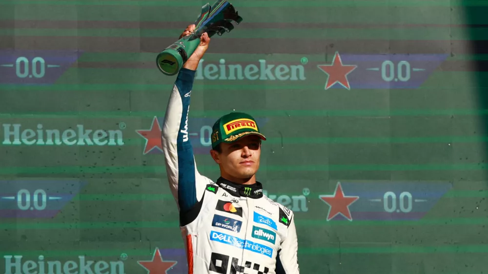 Formula One F1 - Mexico City Grand Prix - Autodromo Hermanos Rodriguez, Mexico City, Mexico - October 26, 2025 McLaren's Lando Norris celebrates with a trophy on the podium after winning the Mexico City Grand Prix REUTERS/Raquel Cunha