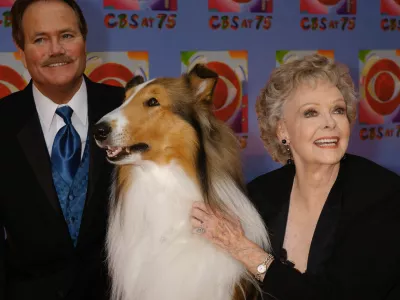 FILE - June Lockhart, right, who played the character of Ruth Martin, mother of Timmy Martin, played by Jon Provost, left, during the classic series "Lassie," poses for a photograph with Lassie, 9th generation, during arrivals at CBS's 75th anniversary celebration Sunday, Nov. 2, 2003, in New York. (AP Photo/Louis Lanzano, File)