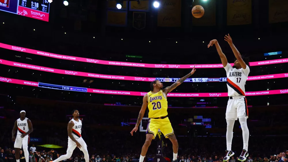 Portland Trail Blazers guard Shaedon Sharpe (17) shoots the ball against Los Angeles Lakers guard Nick Smith Jr. (20) during the second half of an NBA basketball game Monday, Oct. 27, 2025, in Los Angeles. (AP Photo/Ethan Swope)