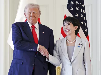 President Donald Trump, left, and Japanese Prime Minister Sanae Takaichi shake hands before their summit talk at Akasaka Palace in Tokyo, Tuesday, Oct. 28, 2025. (Kyodo News via AP)