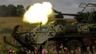 Service members of the 58th Separate Motorized Infantry Brigade of the Ukrainian Armed Forces fire a cannon of a BTR-4 armoured personnel carrier during military exercises at a training ground, amid Russia's attack on Ukraine, in Kharkiv region, Ukraine August 11, 2025. REUTERS/Sofiia Gatilova