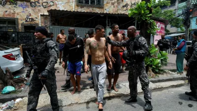 Members of the military police special unit detain suspected drug dealers during a police operation against drug trafficking at the favela do Penha, in Rio de Janeiro, Brazil October 28, 2025. REUTERS/Aline Massuca