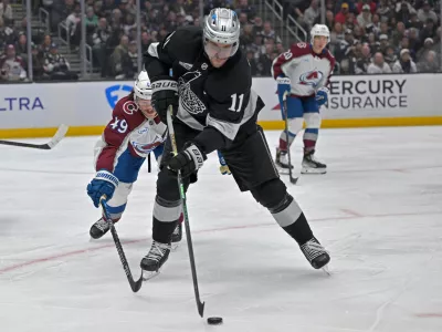 Oct 7, 2025; Los Angeles, California, USA; Los Angeles Kings center Anze Kopitar (11) controls the puck during the second period against the Colorado Avalanche at Crypto.com Arena. Mandatory Credit: Jayne Kamin-Oncea-Imagn Images