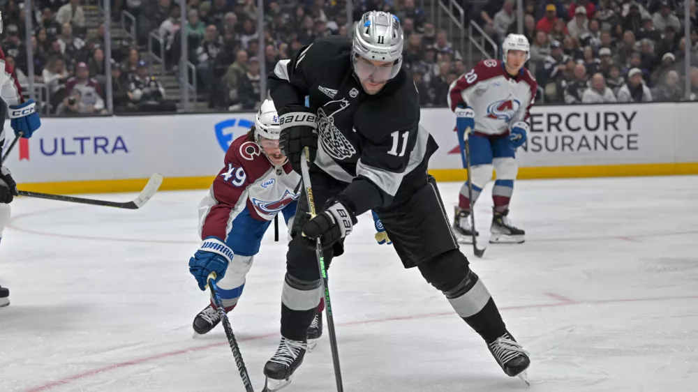 Oct 7, 2025; Los Angeles, California, USA; Los Angeles Kings center Anze Kopitar (11) controls the puck during the second period against the Colorado Avalanche at Crypto.com Arena. Mandatory Credit: Jayne Kamin-Oncea-Imagn Images