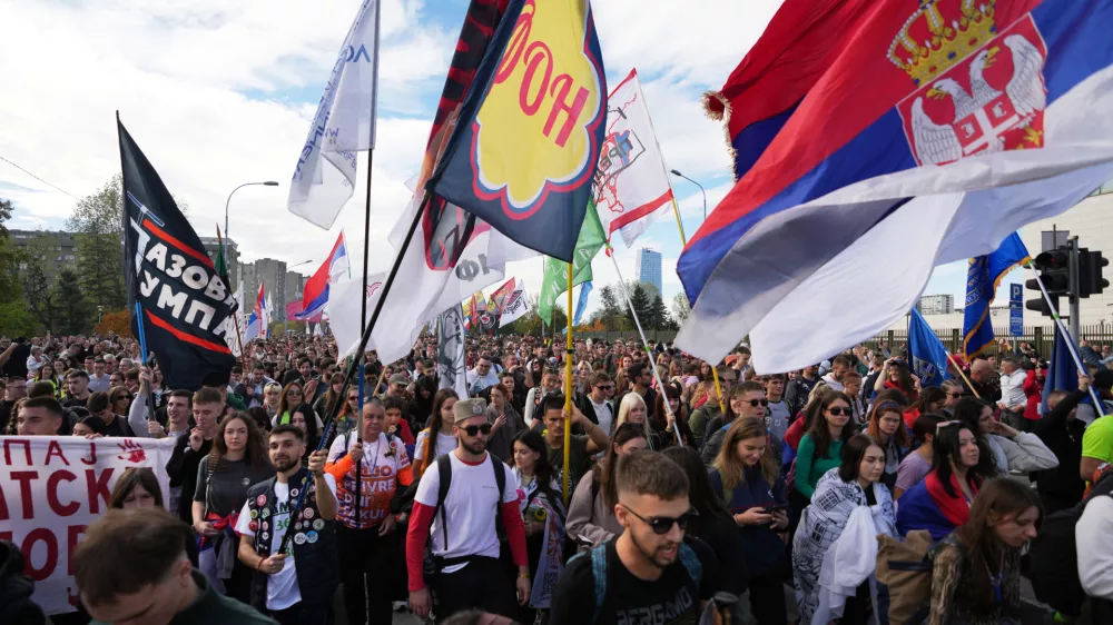 People gather, among them students, to walk on the street towards the northern city of Novi Sad, for a huge rally on Nov. 1 marking the first anniversary of a train station disaster that killed 16 people, in Belgrade, Serbia, Thursday, Oct. 30, 2025. (AP Photo/Darko Vojinovic)