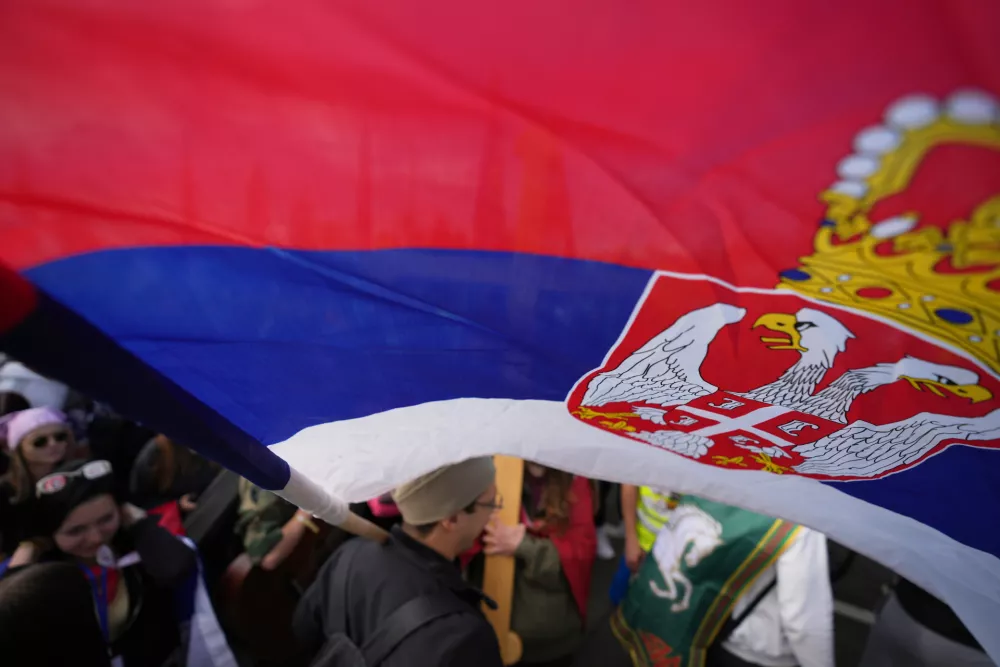 People gather, among them students, to walk on the street towards the northern city of Novi Sad, for a huge rally on Nov. 1 marking the first anniversary of a train station disaster that killed 16 people, in Belgrade, Serbia, Thursday, Oct. 30, 2025. (AP Photo/Darko Vojinovic)