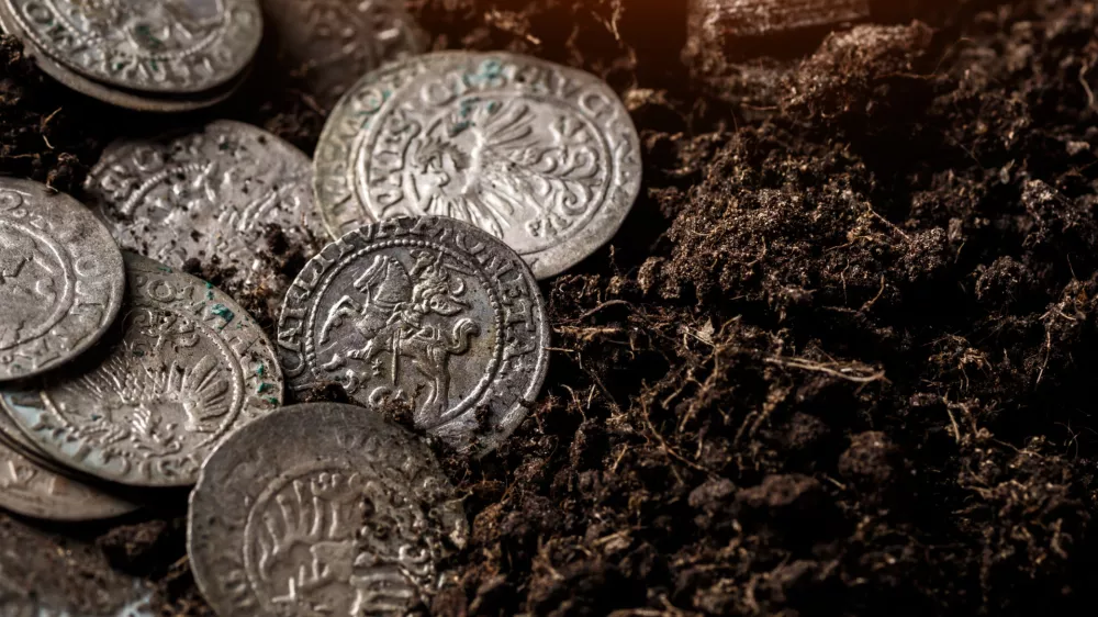 Closeup view of medieval European silver coins.Zygmunt III Waza.Ancient silver coins.Numismatics.silver coins covered in dirt.Antikvariat.