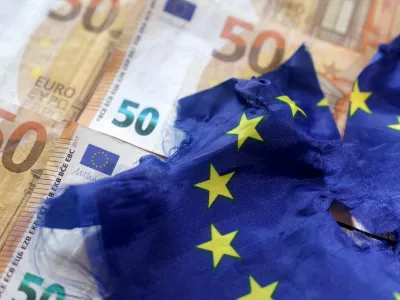 FILE PHOTO: A torn European Union flag is placed on Euro banknotes, September 7, 2022 in this picture illustration. REUTERS/Dado Ruvic/Illustration/File Photo