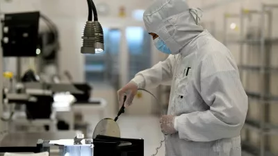FILE PHOTO: An employee works with a wafer in a production line of Dutch semiconductor company Nexperia, in Hamburg, Germany, June 27, 2024. REUTERS/Fabian Bimmer/File Photo