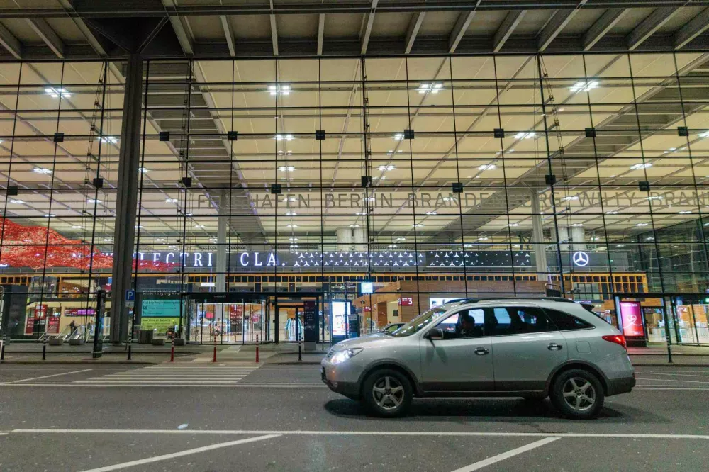 A car sits outside Berlin Brandenburg Airport after it was closed earlier in the evening due to a drone sighting, Friday, Oct. 31, 2025, in Sch&ouml;nefeld, Germany. (Carsten Koall/dpa via AP)