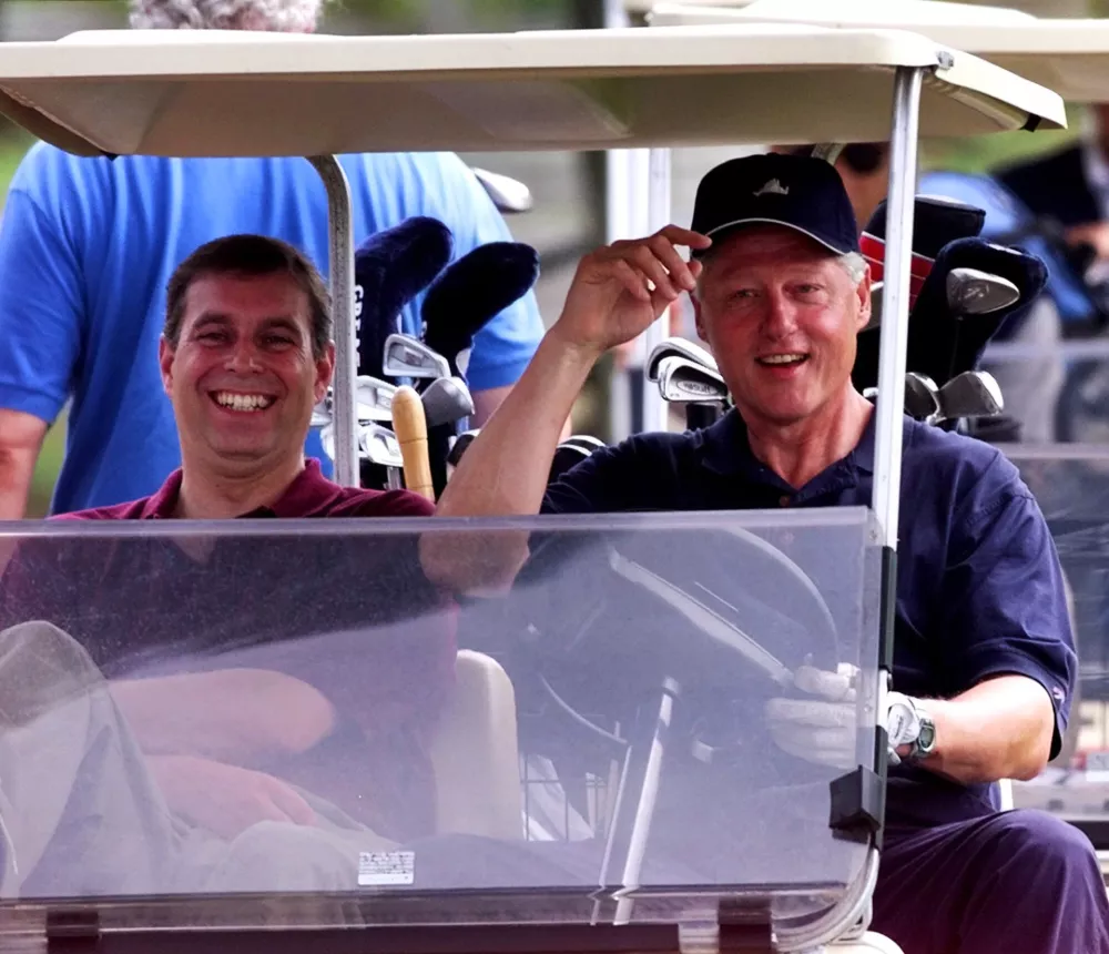 FILE - President Clinton, right, heads out to play a round of golf with Prince Andrew, left, at the Farm Neck Golf Club in Oak Bluffs, Mass., on Martha's Vineyard Friday, Aug. 27, 1999. (AP Photo/Greg Gibson, file)