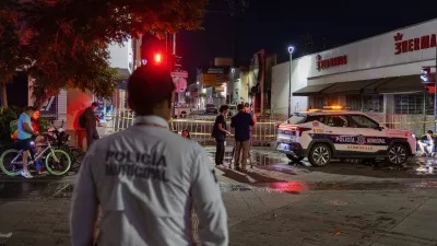 Policeman stands near a convenience store destroyed by a fire in Hermosillo, Sonora state, Mexico, Saturday, Nov. 1, 2025. (AP Photo/Abraham Tellez)