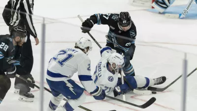 Tampa Bay Lightning center Anthony Cirelli (71) fights for the puck against Utah Mammoth center Barrett Hayton (27) during the third period of an NHL hockey game Sunday, Nov. 2, 2025, in Salt Lake City. (AP Photo/Melissa Majchrzak)