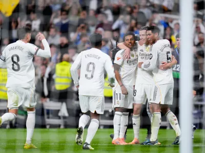Real Madrid's Alvaro Carreras, second from right, celebrates after scoring his side's fourth goal with from left: Federico Valverde, Endrick, Rodrygo and Jude Bellingham, right, during the Spanish La Liga soccer match between Real Madrid and Valencia in Madrid, Spain, Saturday, Nov. 1, 2025. (AP Photo/Manu Fernandez)